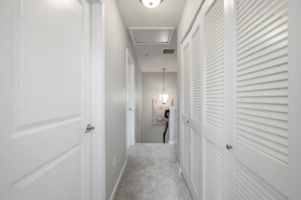 Bright and inviting hallway with ample storage, leading to well-lit living spaces and a cozy atmosphere.