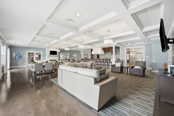 Spacious community gathering area featuring modern decor, abundant seating, and a welcoming atmosphere for social events.