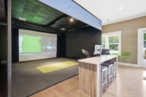 Experience the clubhouse's state-of-the-art golf simulator room, perfect for practice and entertainment.