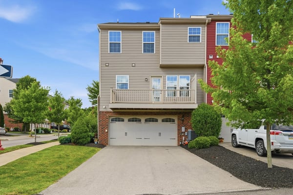 Spacious end-unit townhouse featuring a two-car garage and a private balcony overlooking landscaped grounds.