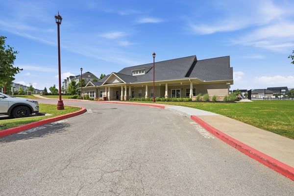Spacious community center featuring ample parking and lush landscaping, ideal for gatherings and events.