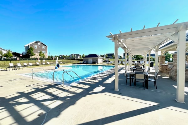 Enjoy a refreshing poolside retreat with ample seating and convenient amenities for relaxation and fun.