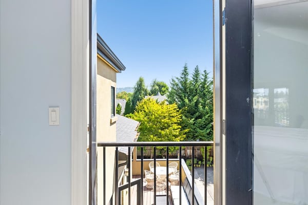 This Juliet balcony overlooks the same spaces as the one below in the dining room; the wrap-around deck off the kitchen and the patio garden below.