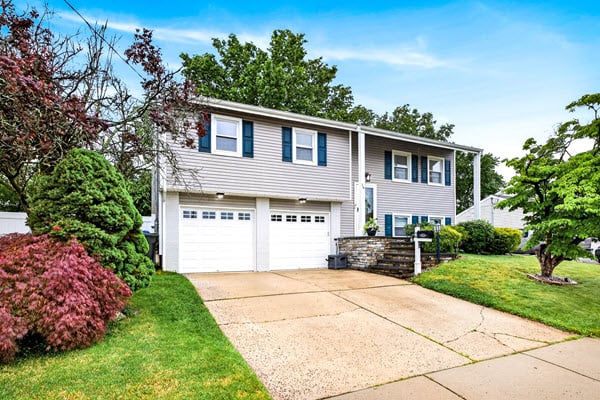 Charming bi-level home with lush greenery.