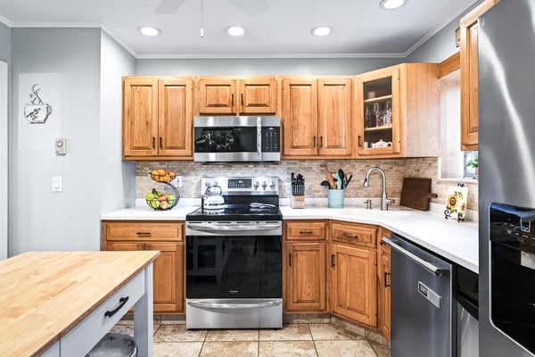 Charming kitchen with warm wood accents, Corian counters.