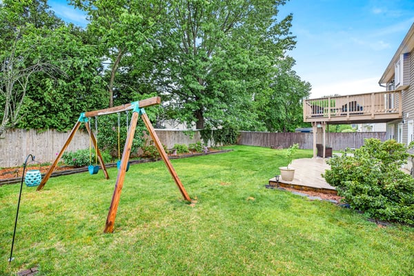 Spacious yard with swing set charm.