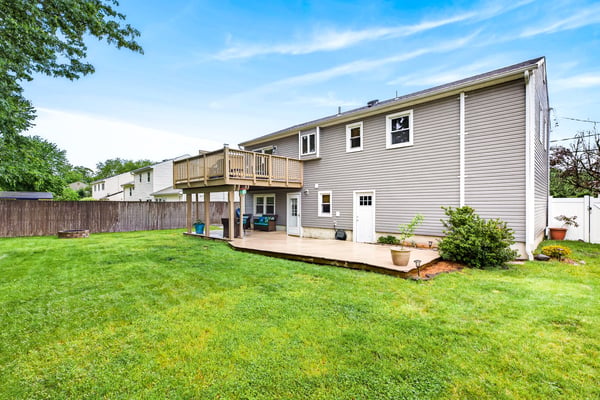 Spacious backyard with large deck and patio.