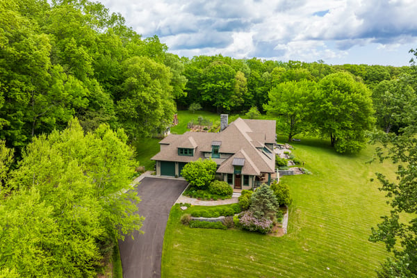 Spacious home nestled on a lush, green lot, offering privacy and natural beauty in a tranquil setting.