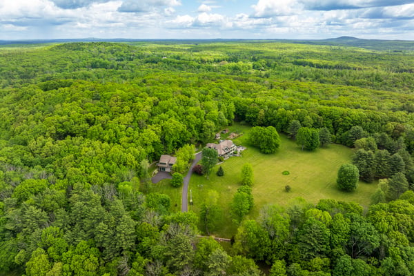 Explore this expansive property surrounded by lush greenery, offering privacy and a unique retreat experience.