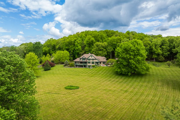 Spacious home nestled on expansive land, surrounded by lush greenery and scenic views, perfect for outdoor enthusiasts.