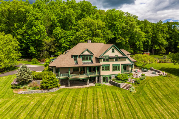 Spacious home nestled among lush greenery, featuring expansive outdoor space and ample room for entertaining.