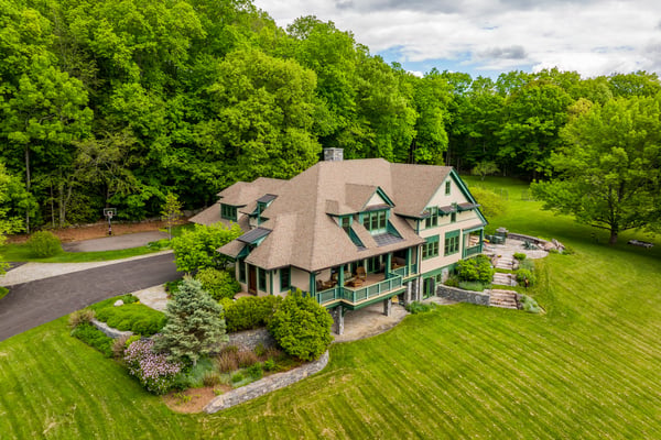 Nestled amid lush greenery, this spacious home offers expansive outdoor space and scenic views for your enjoyment.