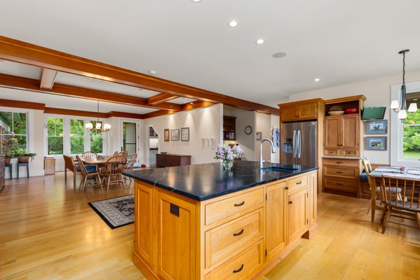 Spacious kitchen with a large island, seamlessly connecting to a bright dining area for entertaining.