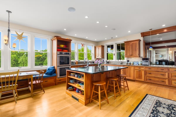 Spacious kitchen featuring abundant natural light, modern appliances, and a convenient dining area with scenic views.