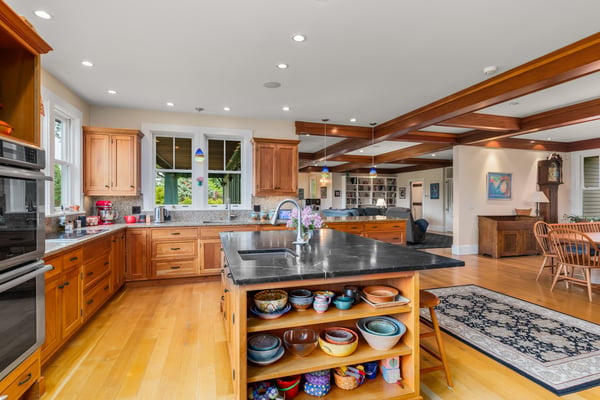 Spacious kitchen featuring ample cabinetry, a large island, and integrated dining area, perfect for gatherings.
