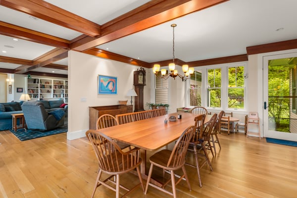 Spacious dining area with natural light, featuring a large table and open flow to the living room.