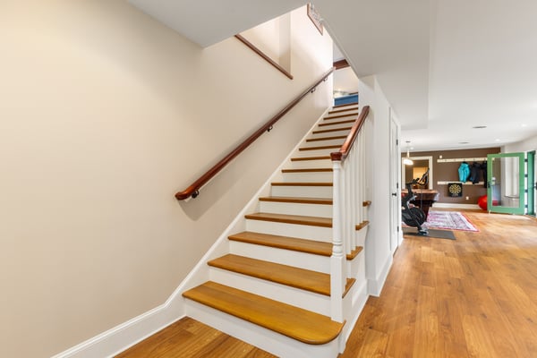 Bright and welcoming staircase leads to versatile living spaces perfect for relaxation or entertainment.
