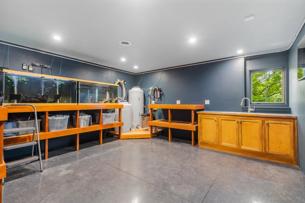 Versatile workspace featuring ample storage, ideal for creative projects or hobbies, with natural light.