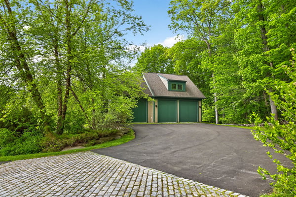 Secluded garage nestled among lush greenery, offering privacy and easy access to outdoor adventures.