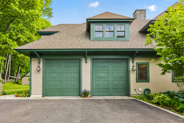 Discover this beautifully designed home featuring a spacious two-car garage and lush surrounding landscaping.