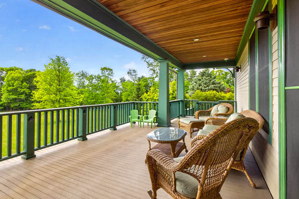 Relax on this spacious porch, surrounded by lush greenery and stunning views, perfect for outdoor gatherings.