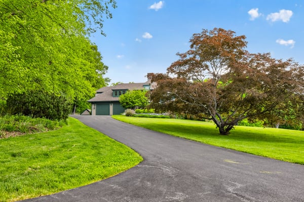 Discover this inviting home set amidst lush greenery, featuring a spacious driveway and panoramic views.