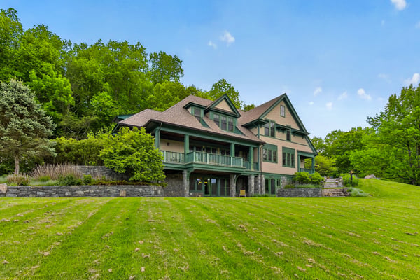 Spacious home nestled in nature, featuring multiple outdoor areas and ample room for relaxation and entertainment.