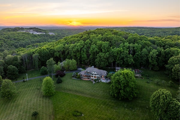 Sprawling estate set against a backdrop of lush greenery and captivating sunset views, perfect for relaxation.