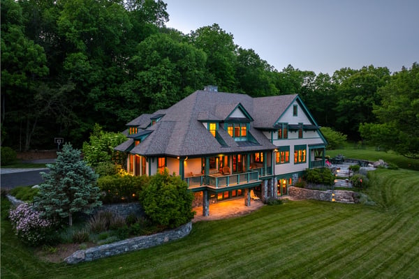Expansive home nestled in nature, featuring generous outdoor spaces and stunning architectural details throughout.