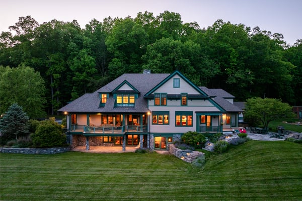 Spacious home surrounded by lush greenery, featuring expansive outdoor spaces and stunning views throughout.