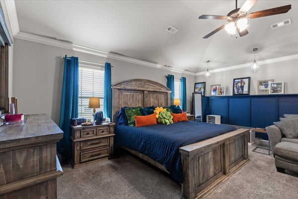 Spacious primary suite featuring high ceilings and modern lighting for a welcoming atmosphere.