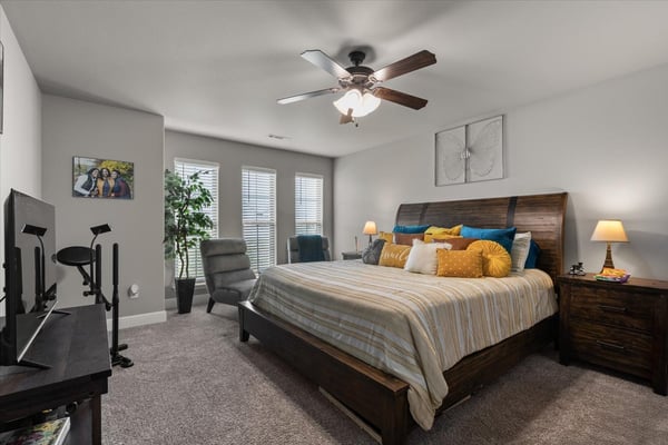 This large bedroom features ample natural light, a spacious layout, and modern amenities for comfort.