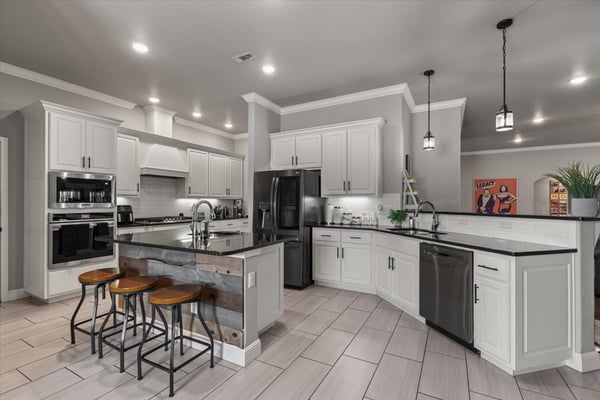 This modern kitchen features sleek cabinetry, a spacious island, and contemporary appliances, perfect for culinary enthusiasts.