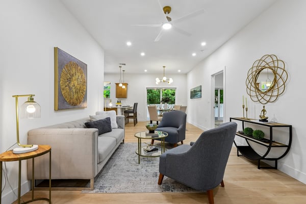 Bright and inviting open-concept living space, featuring modern furnishings and large windows for ample natural light.