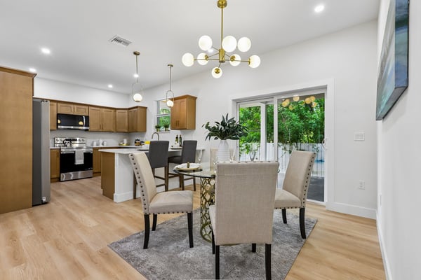 Bright and inviting dining area features modern fixtures and seamless access to outdoor space.