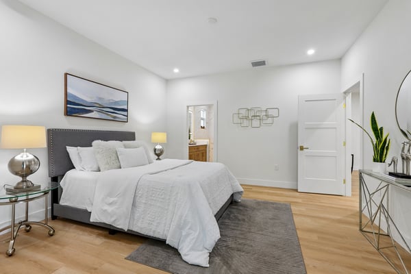 Spacious bedroom featuring modern decor, ample natural light, and a comfortable atmosphere for relaxation.