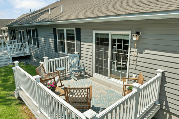 Sunny outdoor space featuring a spacious deck, perfect for relaxing and entertaining in comfort.