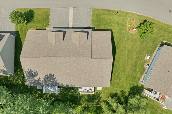 Spacious lot with well-maintained landscaping, featuring a welcoming outdoor space and convenient driveway access.