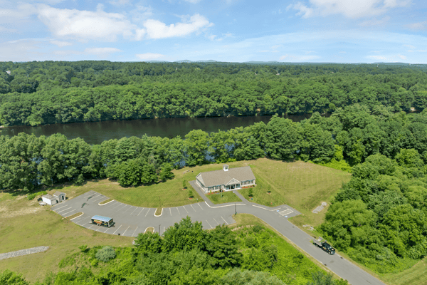 Spacious property with expansive parking and scenic river views, ideal for development or recreational use.