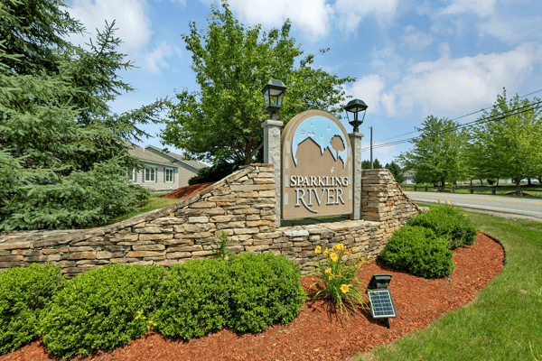 Discover the inviting entrance of Sparkling River, featuring beautiful landscaping and a welcoming community vibe.