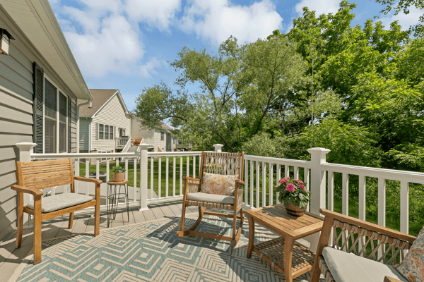 Relax on this inviting deck, surrounded by lush greenery and featuring comfortable seating for outdoor enjoyment.