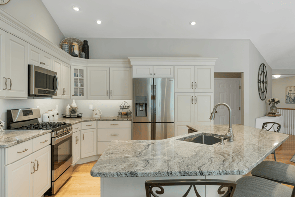 Modern kitchen with sleek granite countertops, stainless steel appliances, and ample cabinetry for convenient storage.