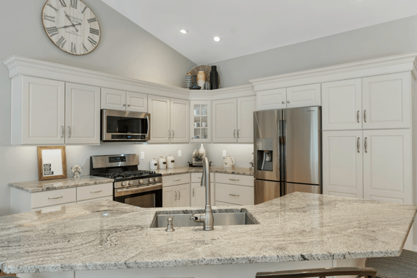Modern kitchen featuring granite countertops, stainless steel appliances, and plenty of cabinetry for storage.