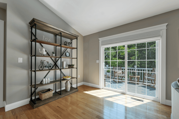Bright living space featuring a modern open layout and large sliding doors leading to a private deck.
