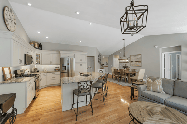 Bright open-concept living space featuring a modern kitchen, spacious dining area, and comfortable seating arrangements.
