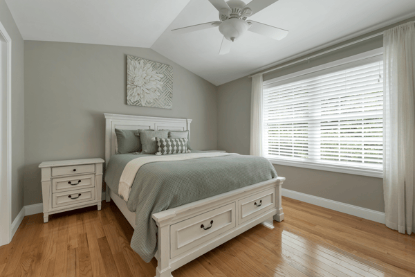 Bright and inviting bedroom featuring a cozy bed, modern furnishings, and abundant natural light.