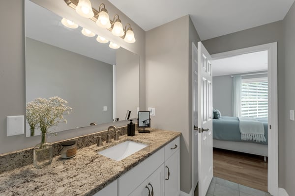 Contemporary bathroom featuring modern fixtures and a clean, open layout, seamlessly connecting to the adjacent bedroom.
