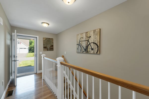 Bright entryway featuring a welcoming atmosphere and modern design, leading to a spacious living area.