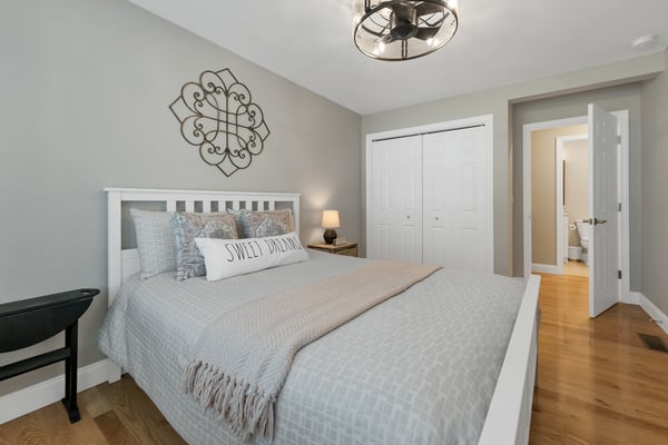 This cozy bedroom features modern decor, ample storage, and easy access to an en-suite bathroom.