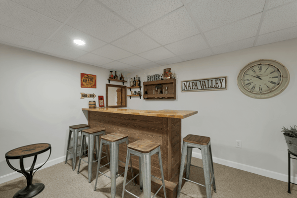 This versatile basement features a well-designed bar area, perfect for entertaining or relaxing with friends.
